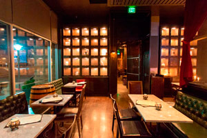 The Stacks - 15 seated | 25 reception<br> With the backdrop of caged tequila lockers, wrought iron screens adorn the space and floor-to-ceiling windows add warmth to the space.