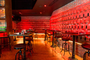 The Cove - 40 reception <br> Red lighting illuminates the space, making it perfect to share a private tasting or intimate reception.