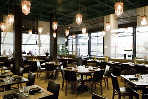 Elevated Dining Room - 65 seated | 65 reception<br />A canopy of custom-blown glass pendants casts a warm glow over the Elevated Dining room.